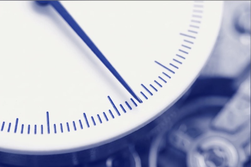 Macro photograph of a precision gauge dial in blueprint blue