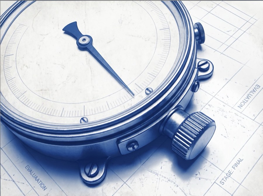 A precision instrument gauge resting on evaluation paperwork marked STAGE: FINAL